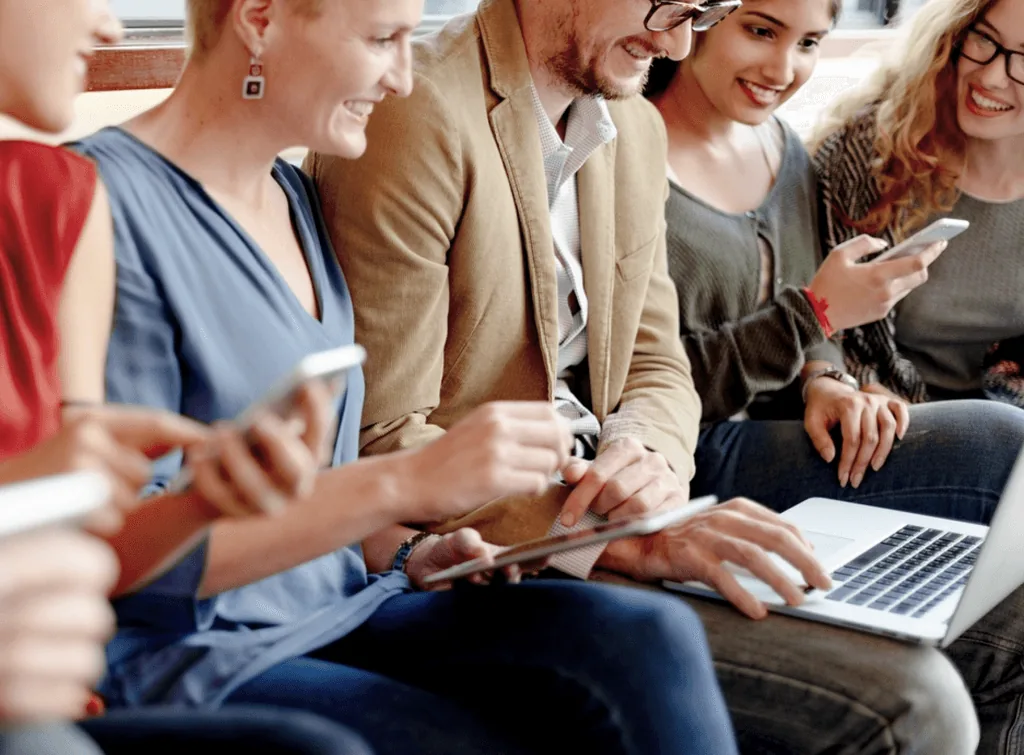 Advisors and clients reviewing a plan together on a laptop and tablet